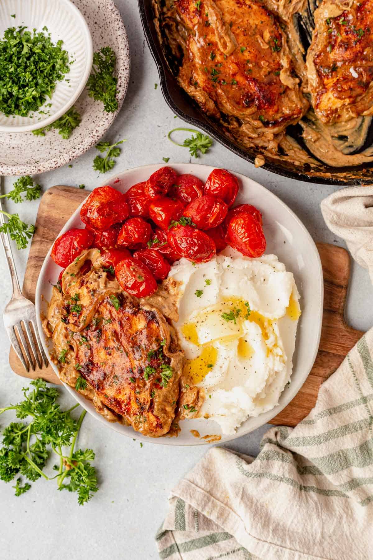 boursin chicken on a plate with cherry tomatoes and mashed potatoes