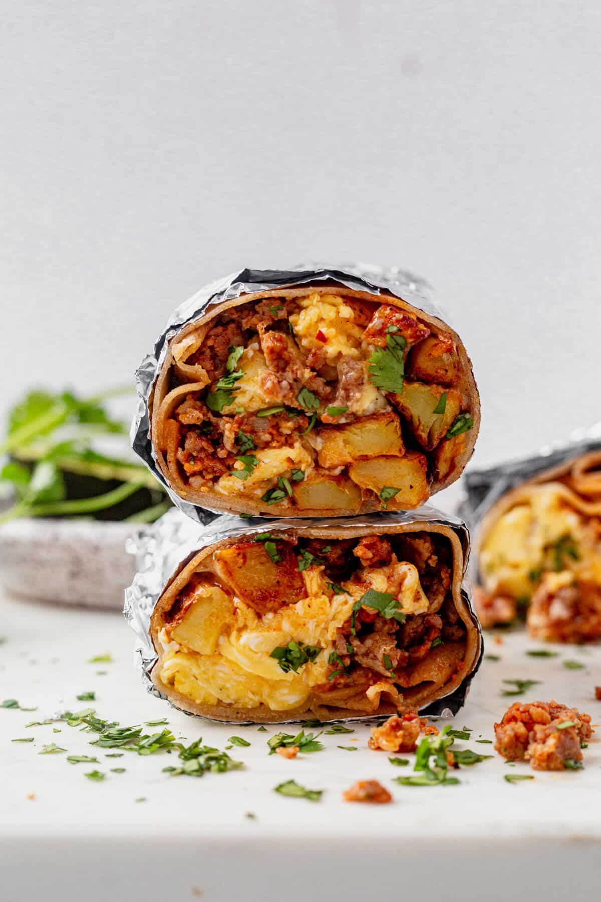 two chorizo breakfast burritos stacked on top of each other